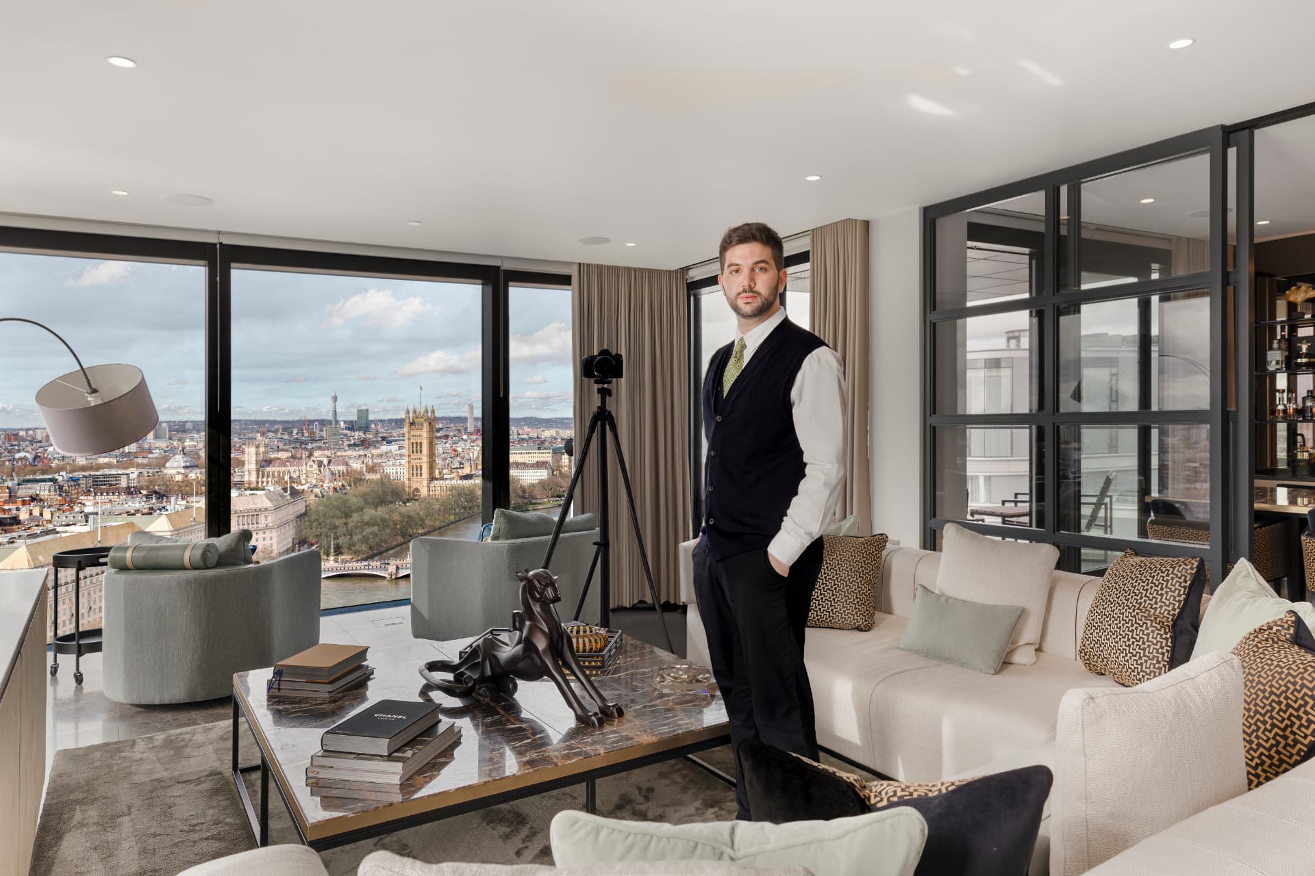 The founder of Photo House Club photographing a riverside London apartment with views over Westminster