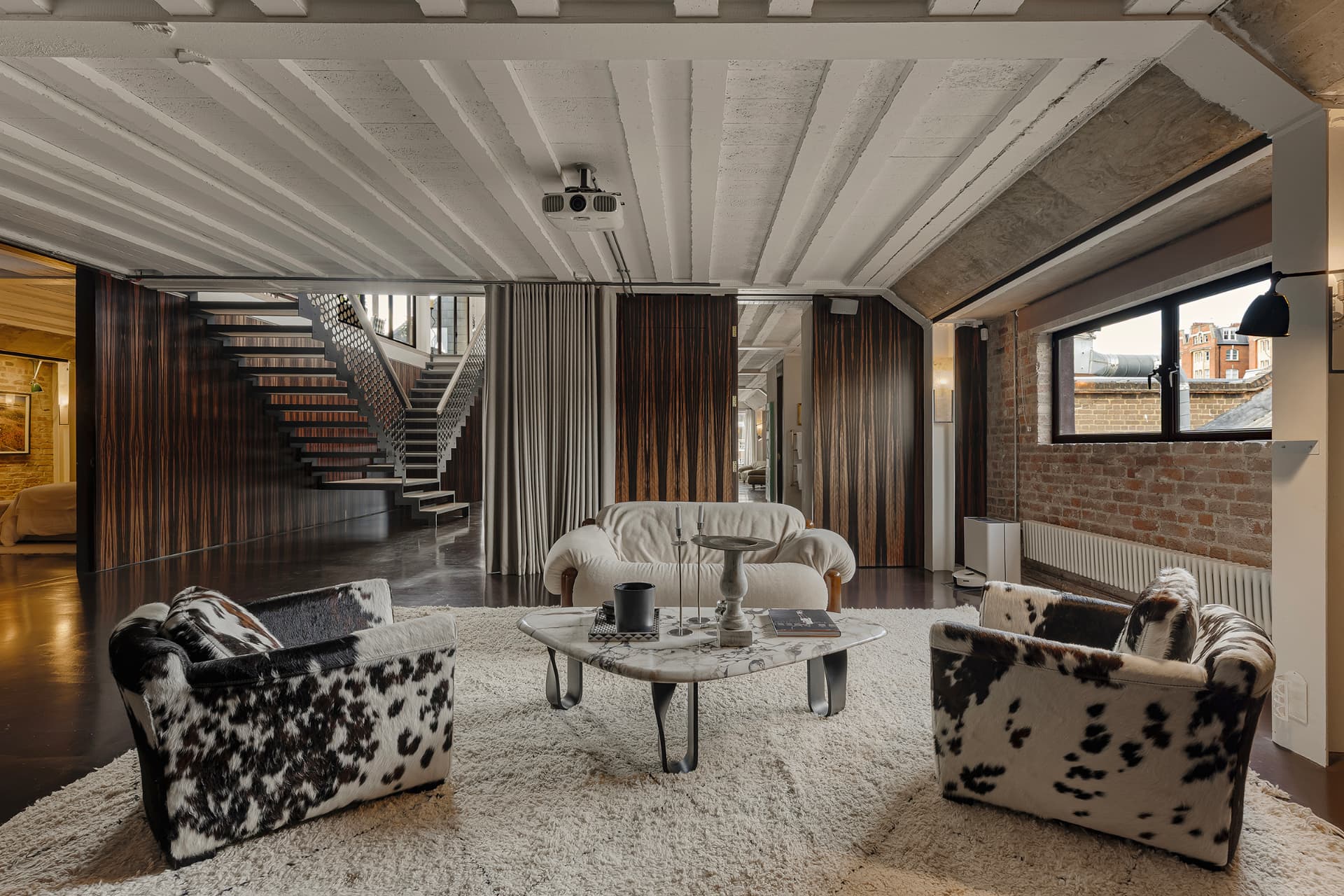 Concrete-vaulted loft living room with ebony panelling and a marble table, Queensway, London